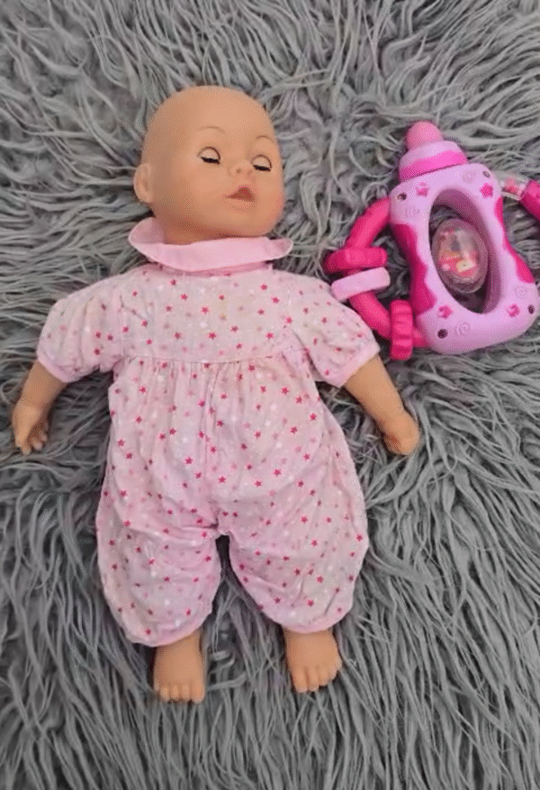 Baby doll with rattle feeder